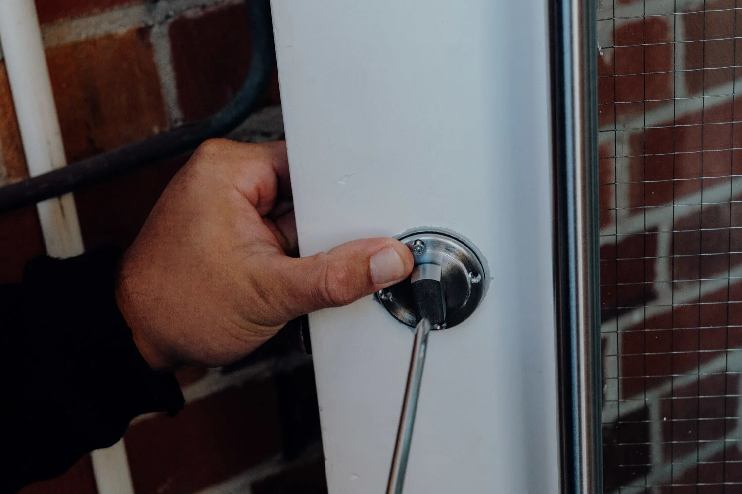 Locksmith changing a lock on a residential door after an emergency lockout