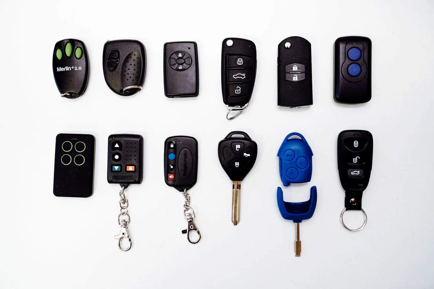 Car remotes laid out on a white table