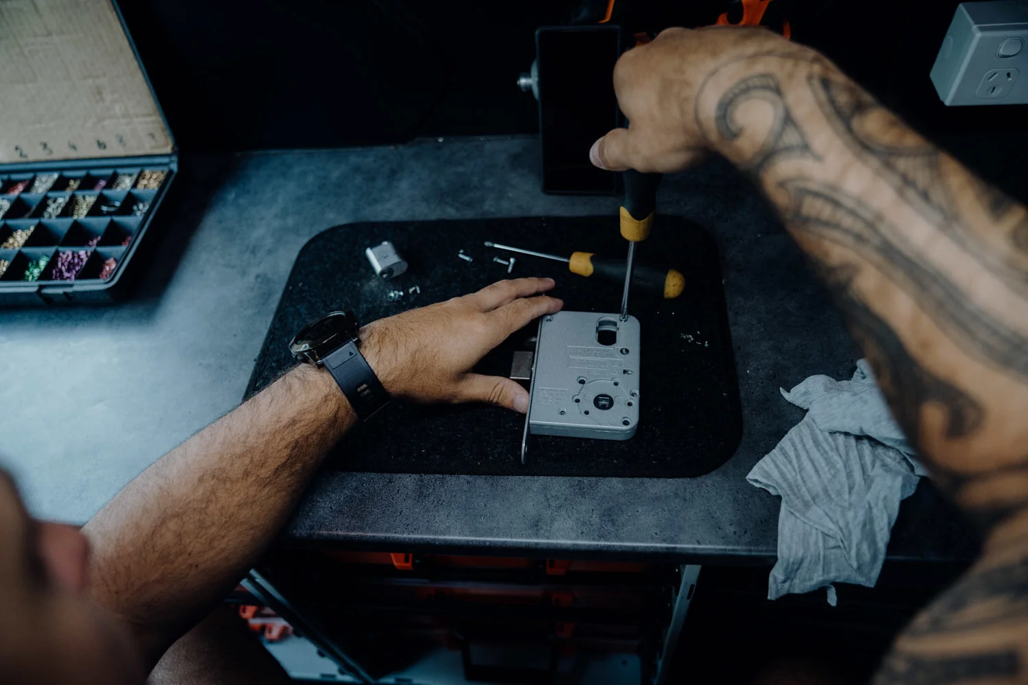 Locksmith changing out a door lock